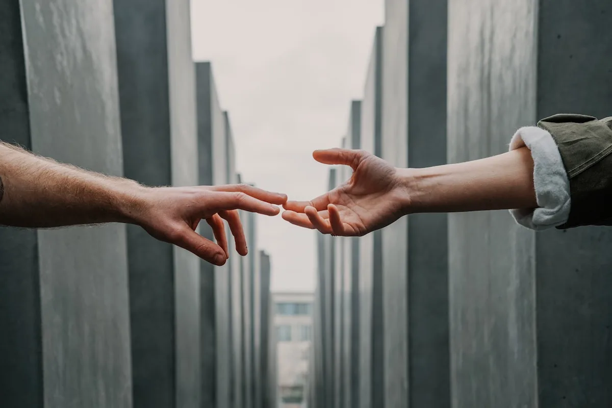 Two hands reaching for each other